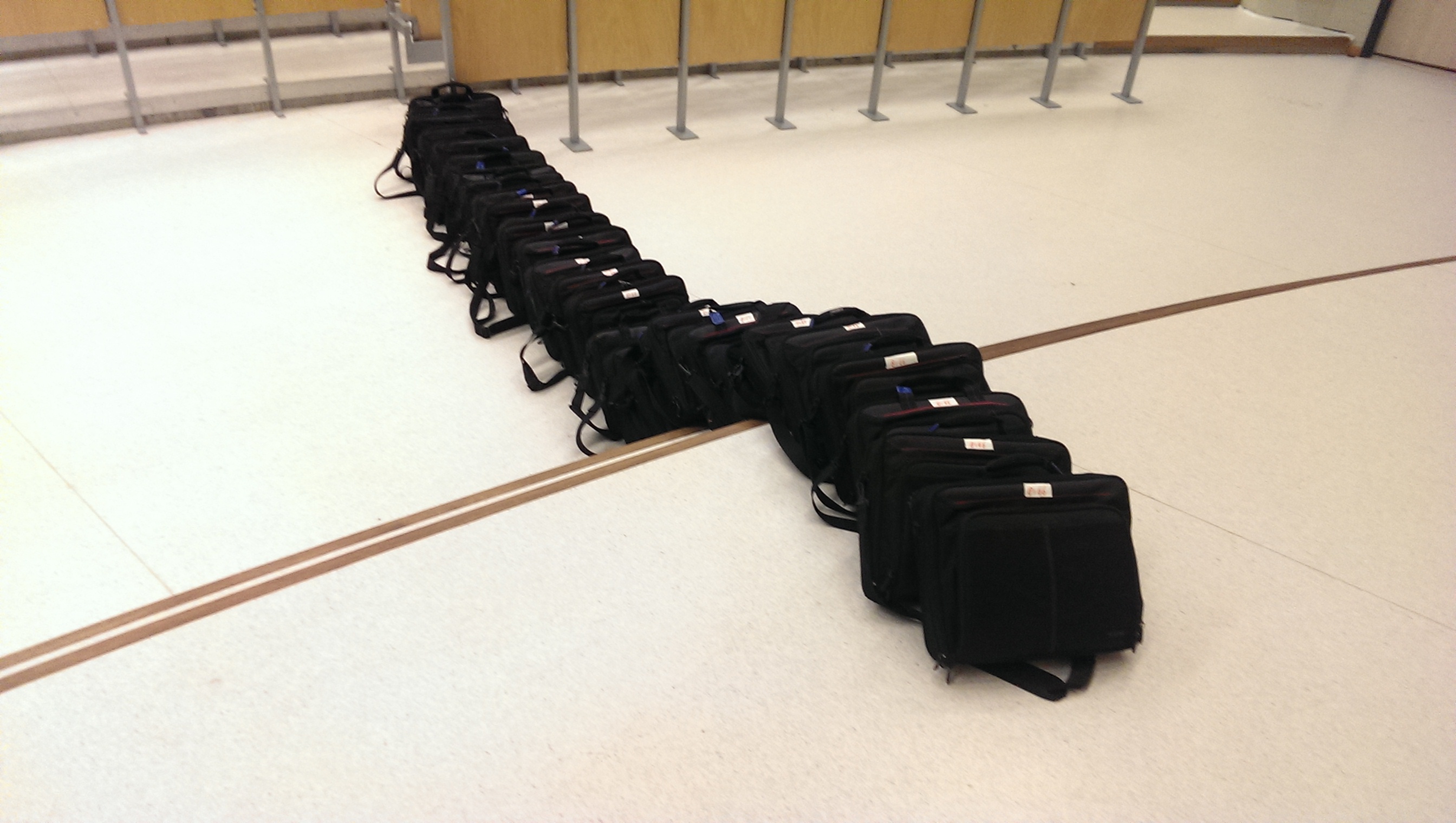 20 bagged laptops standing in a line