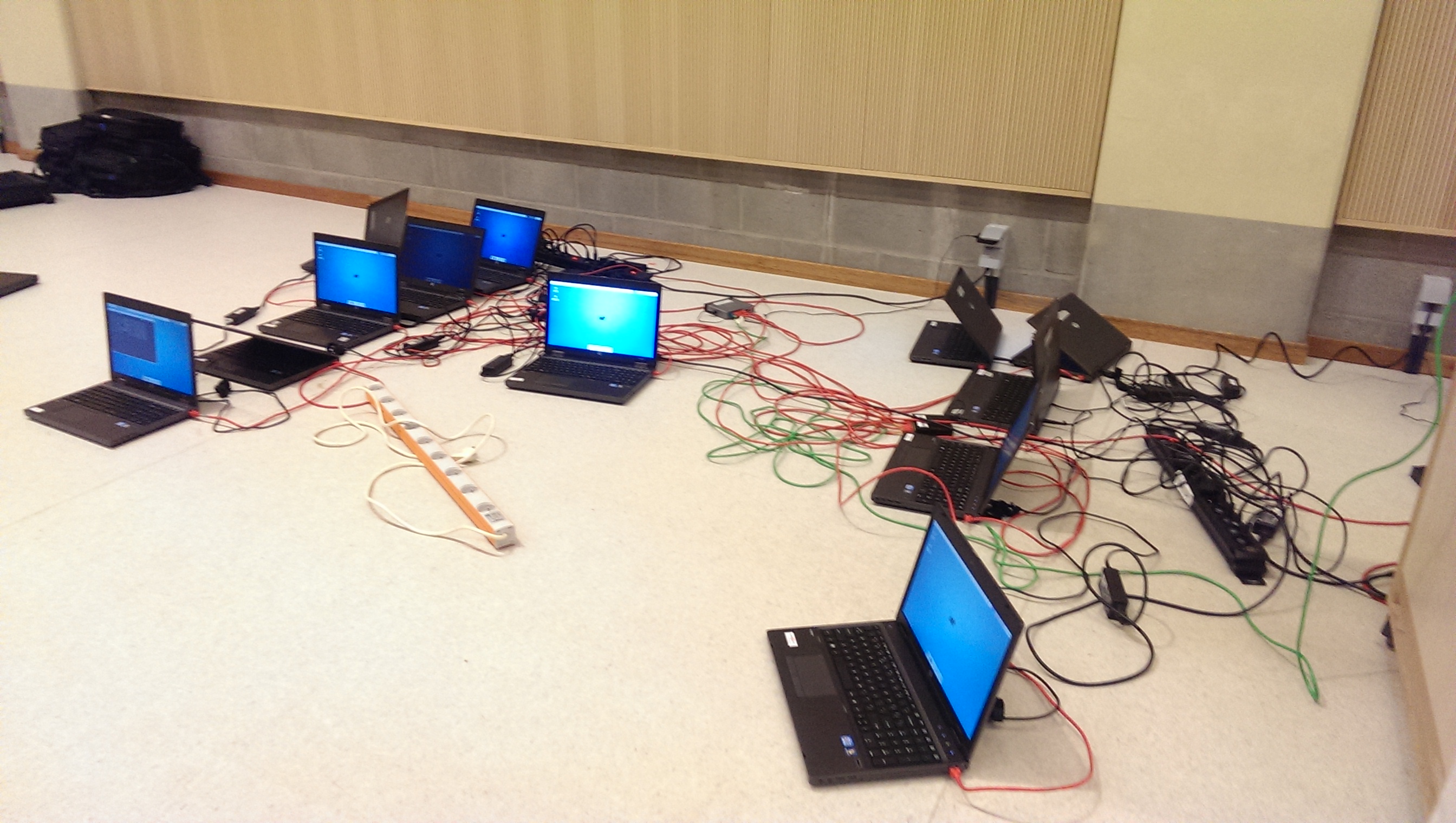 12 laptops next to eachother wired into a single router.